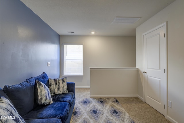 carpeted office space featuring baseboards and visible vents