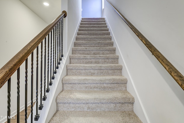 stairway featuring recessed lighting