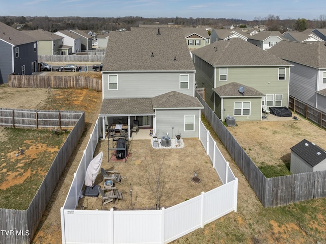 exterior space featuring a residential view, cooling unit, and a fenced backyard