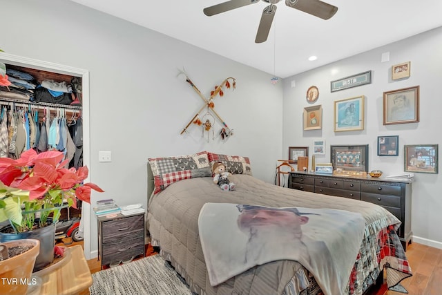 bedroom featuring ceiling fan, baseboards, recessed lighting, wood finished floors, and a closet