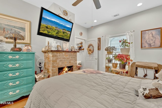 bedroom featuring recessed lighting, visible vents, a ceiling fan, and a fireplace