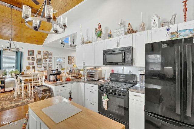 kitchen featuring white cabinetry, wooden ceiling, black appliances, and lofted ceiling