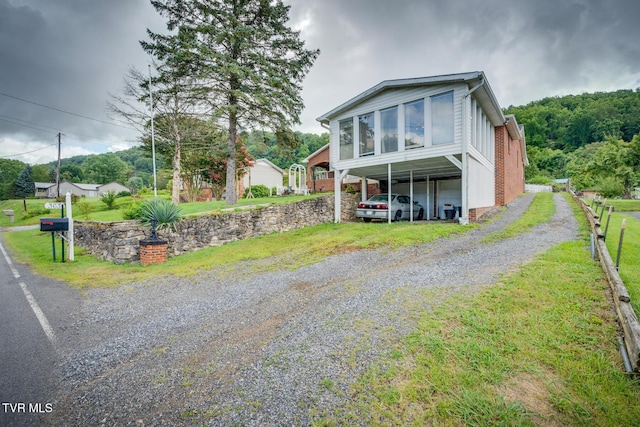 view of front of home with a carport and driveway