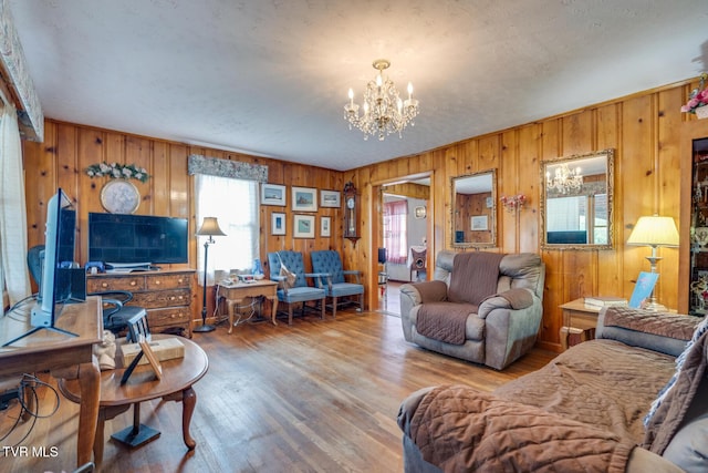 living area featuring a chandelier and wood finished floors