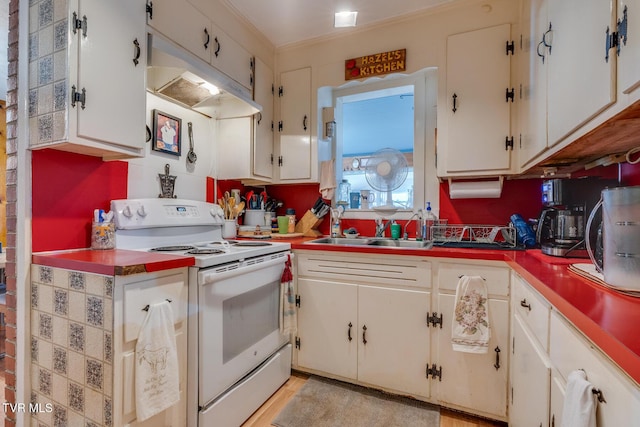 kitchen with under cabinet range hood, electric range, white cabinetry, and a sink