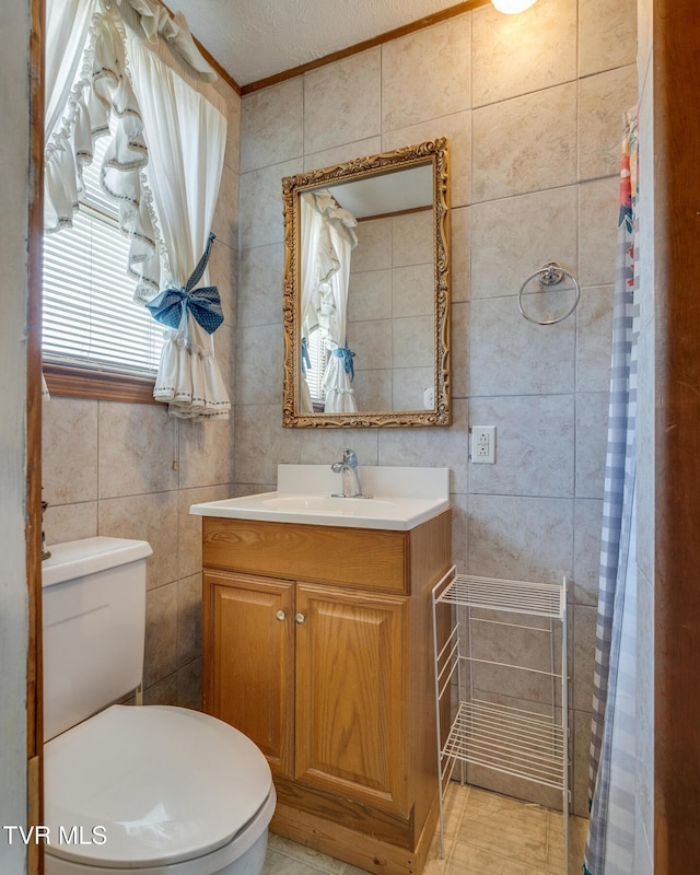 full bathroom featuring vanity, toilet, tile walls, and ornamental molding