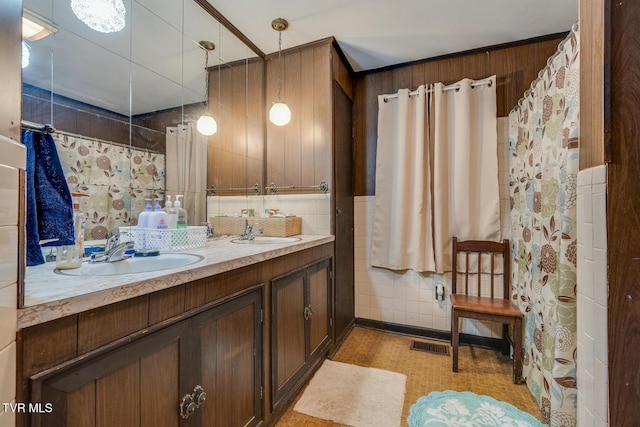 full bathroom with a sink, visible vents, and double vanity