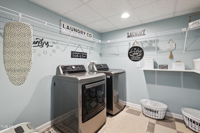 laundry area with washing machine and clothes dryer, laundry area, and baseboards