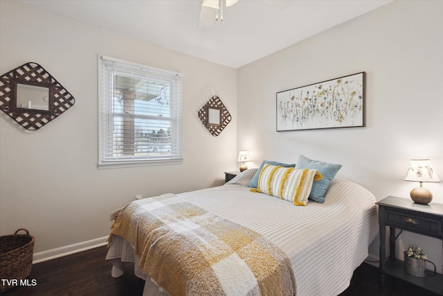 bedroom featuring a ceiling fan, wood finished floors, and baseboards