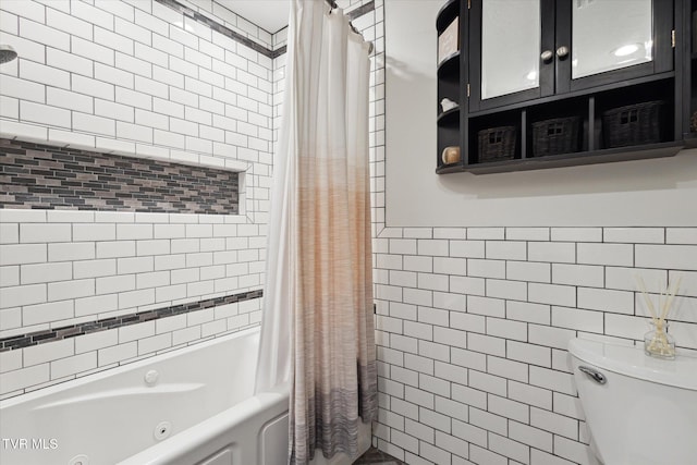 full bathroom featuring toilet, tile walls, and a combined bath / shower with jetted tub