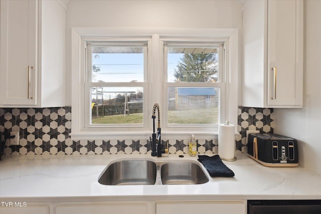 kitchen with dishwashing machine, a healthy amount of sunlight, and a sink