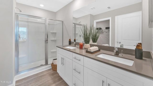 1807 Fox Meadows Cir, Bluff City, TN 37618 - bathroom with a shower stall, wood finished floors, double vanity, and a walk in closet
