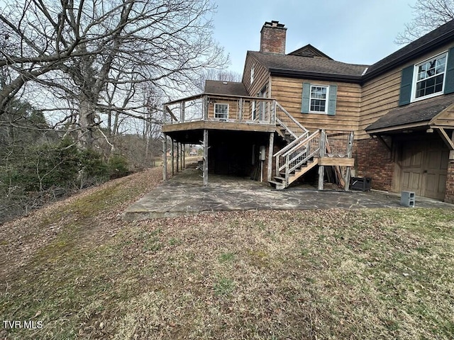 back of property with a patio, stairway, a wooden deck, and a chimney