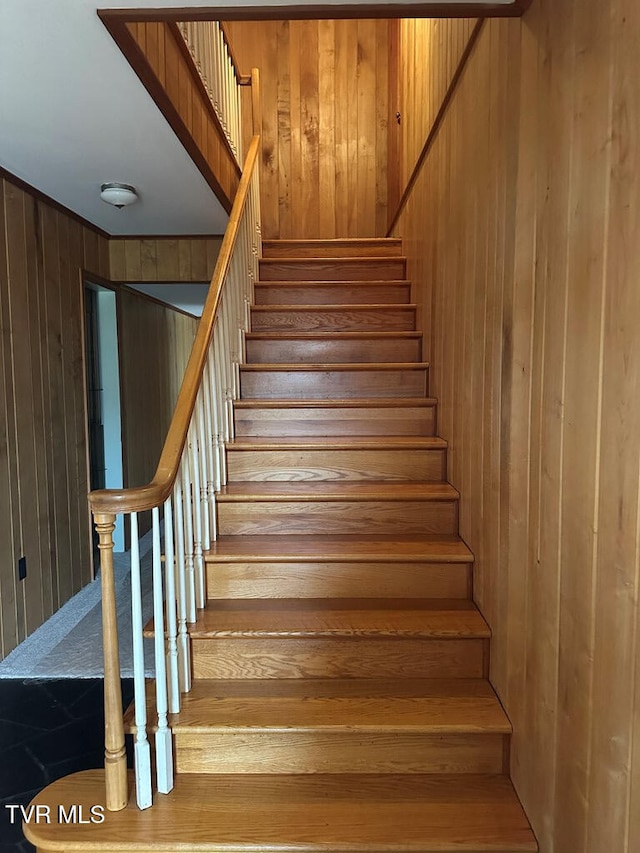 staircase with wooden walls