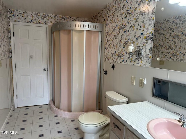 bathroom featuring a wainscoted wall, toilet, wallpapered walls, and vanity