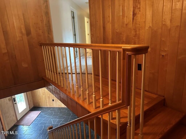 stairway with wood walls