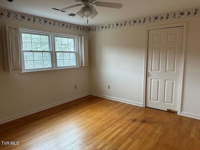 unfurnished bedroom featuring light wood-type flooring, baseboards, and ceiling fan