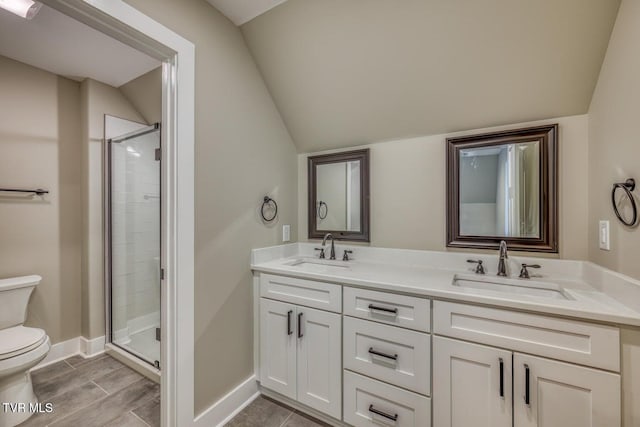 full bathroom featuring vaulted ceiling, a stall shower, toilet, and a sink