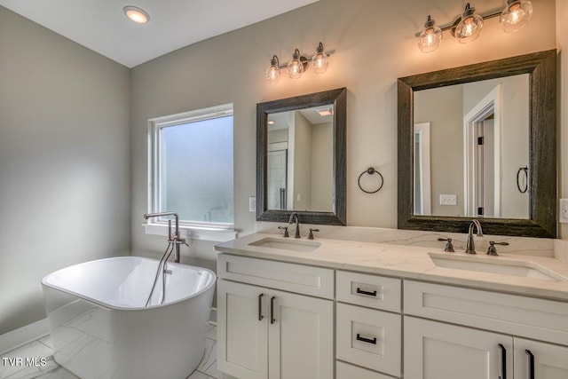 bathroom featuring a soaking tub, double vanity, and a sink