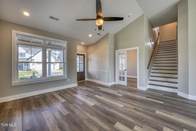 unfurnished living room with dark wood finished floors, stairway, baseboards, and visible vents