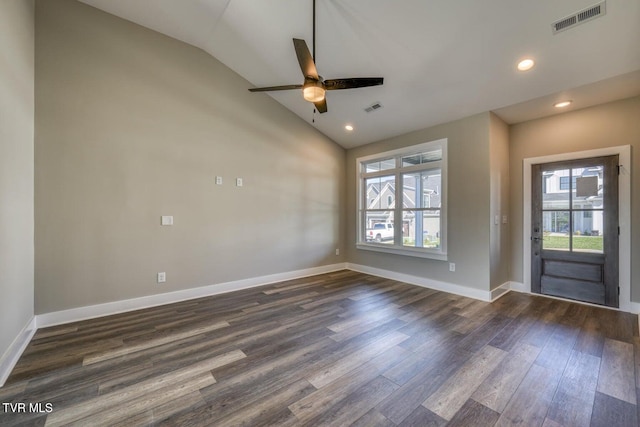 interior space featuring dark wood finished floors, visible vents, baseboards, and lofted ceiling