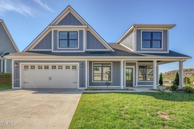 view of front facade with a front lawn, board and batten siding, driveway, and a shingled roof