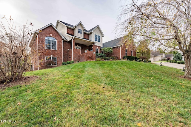 traditional-style home with brick siding and a front lawn