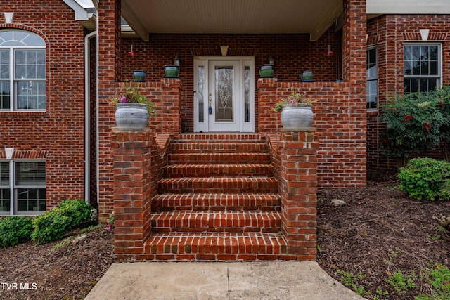 doorway to property with brick siding