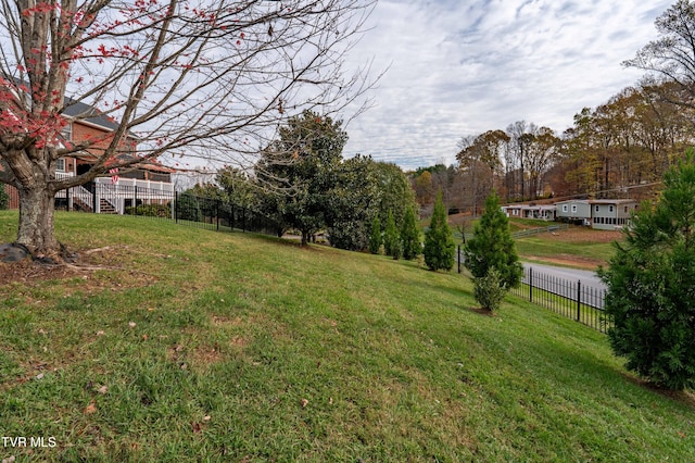 view of yard featuring stairs and fence