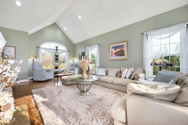 living room with light wood-style flooring, recessed lighting, baseboards, and high vaulted ceiling