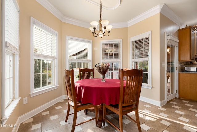 dining room with baseboards, crown molding, and an inviting chandelier