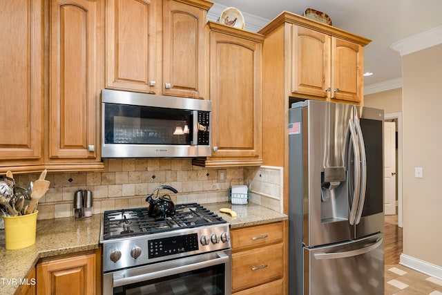 kitchen featuring tasteful backsplash, baseboards, ornamental molding, light stone counters, and stainless steel appliances