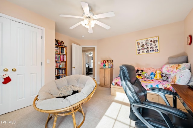 office space featuring light colored carpet and a ceiling fan