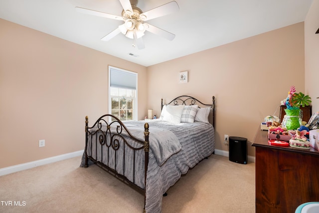 bedroom with light carpet, visible vents, ceiling fan, and baseboards