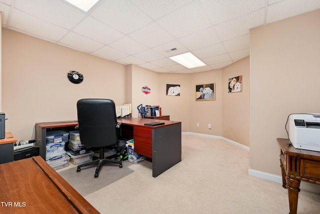 office space featuring visible vents, baseboards, light colored carpet, heating unit, and a paneled ceiling