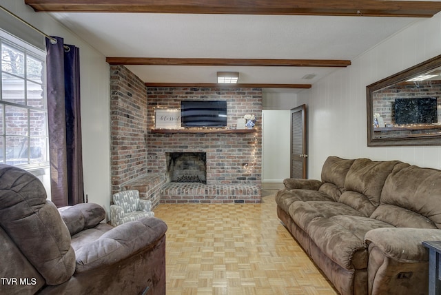 living area featuring a brick fireplace, visible vents, beamed ceiling, and a textured ceiling