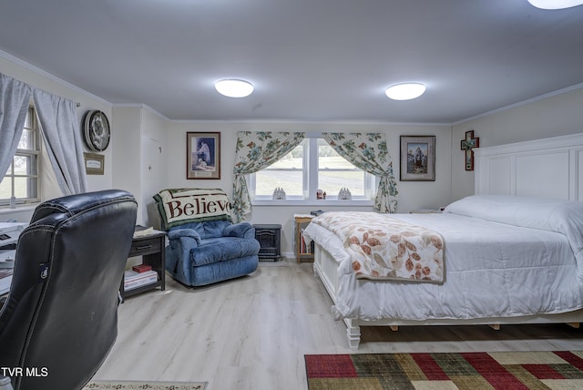 bedroom with light wood-type flooring and crown molding