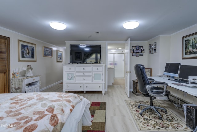 bedroom with light wood-style flooring, baseboards, ensuite bath, and ornamental molding