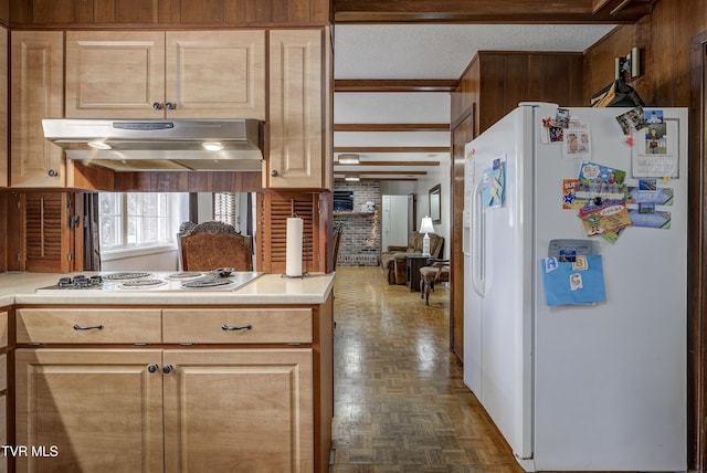 kitchen with white appliances, light countertops, under cabinet range hood, and a textured ceiling