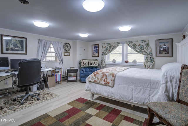 bedroom featuring light wood finished floors and ornamental molding