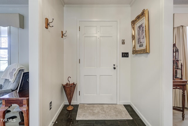 entrance foyer featuring baseboards and ornamental molding