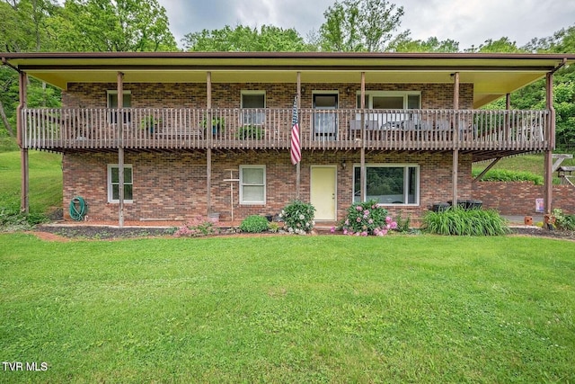 back of house featuring a yard and brick siding