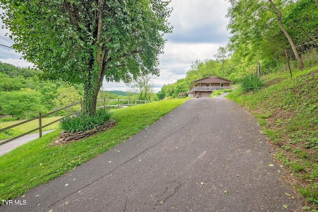 view of front of home featuring fence and driveway