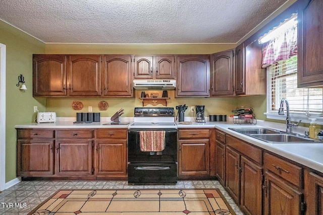 kitchen with a sink, under cabinet range hood, a textured ceiling, electric range oven, and light countertops