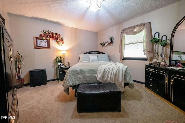 carpeted bedroom featuring baseboards and a textured ceiling