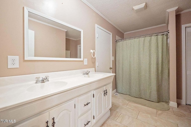 bathroom featuring a sink, a textured ceiling, ornamental molding, and double vanity