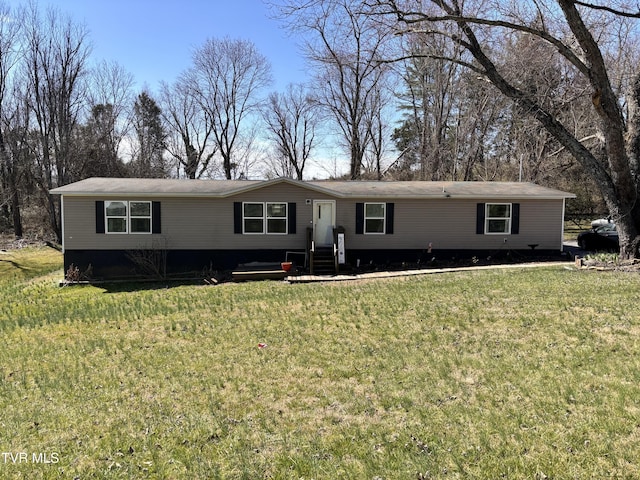 manufactured / mobile home with entry steps and a front lawn