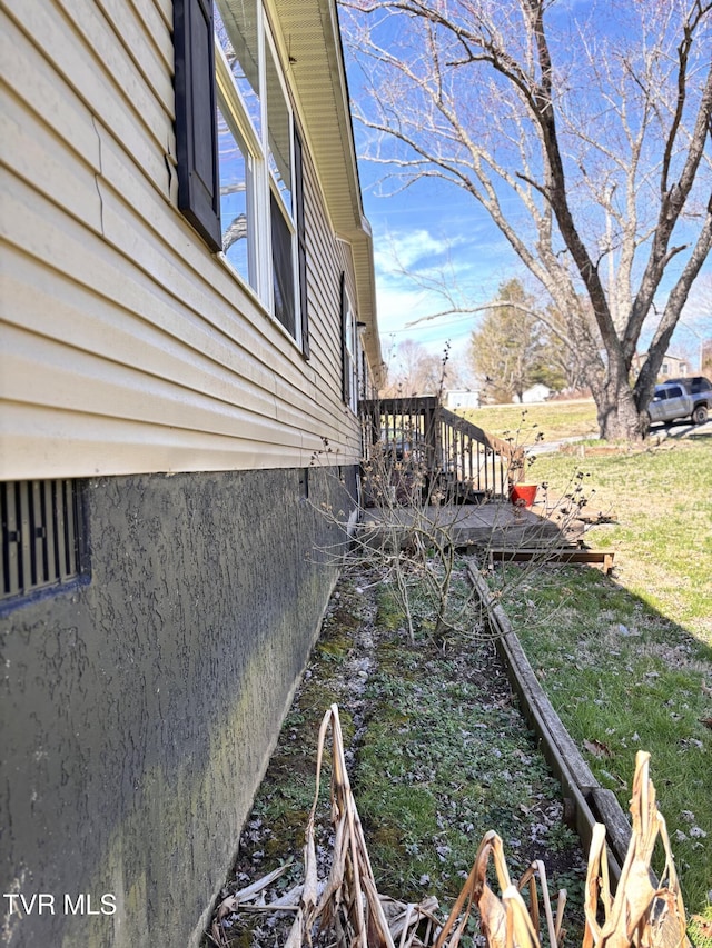 view of property exterior featuring a wooden deck