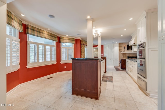 kitchen featuring double oven, recessed lighting, white cabinetry, light tile patterned floors, and backsplash