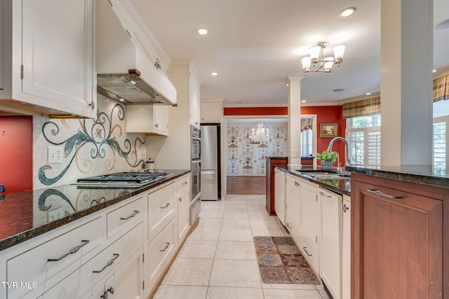 kitchen with custom range hood, a sink, a chandelier, and stainless steel appliances
